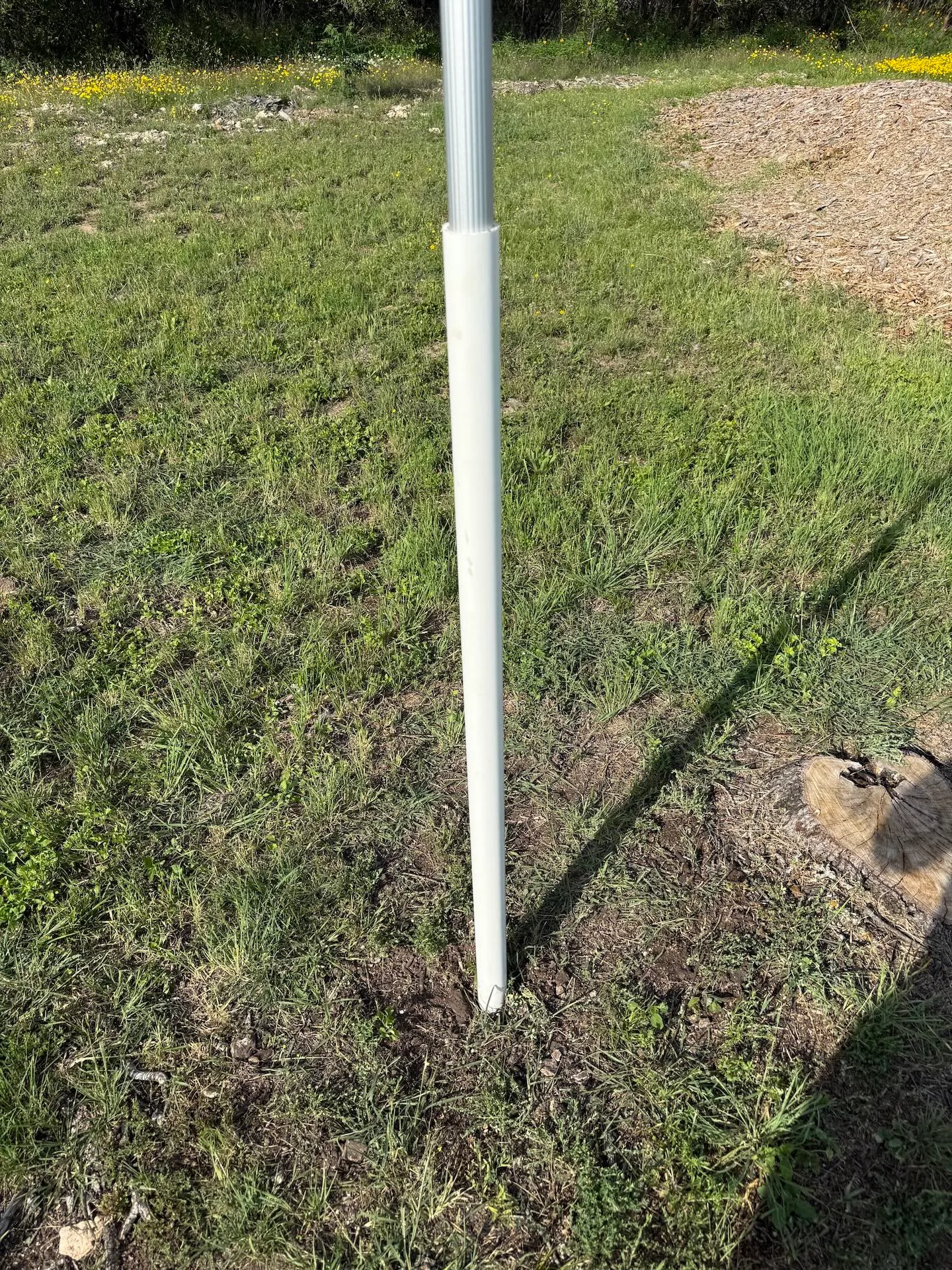 The DOCAZOO pole slid into a section of 1.5-inch PVC pipe buried in the ground as a sleeve