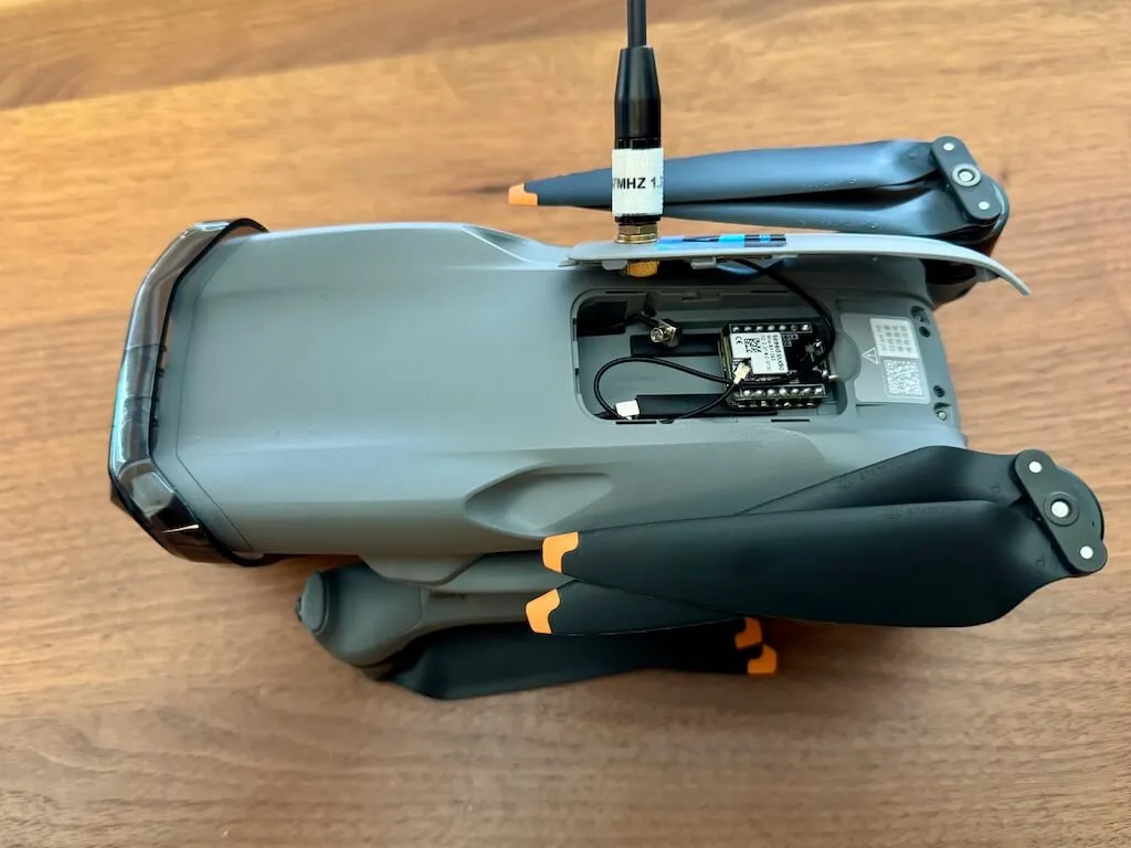 The DJI Air 3 folded up for transport with the modified dongle cover and SMA antenna in place