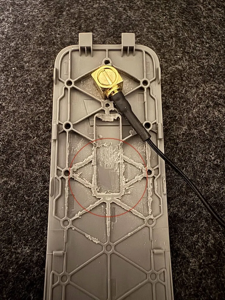 The replacement dongle cover after drilling, with the SMA bulkhead connector mounted through it