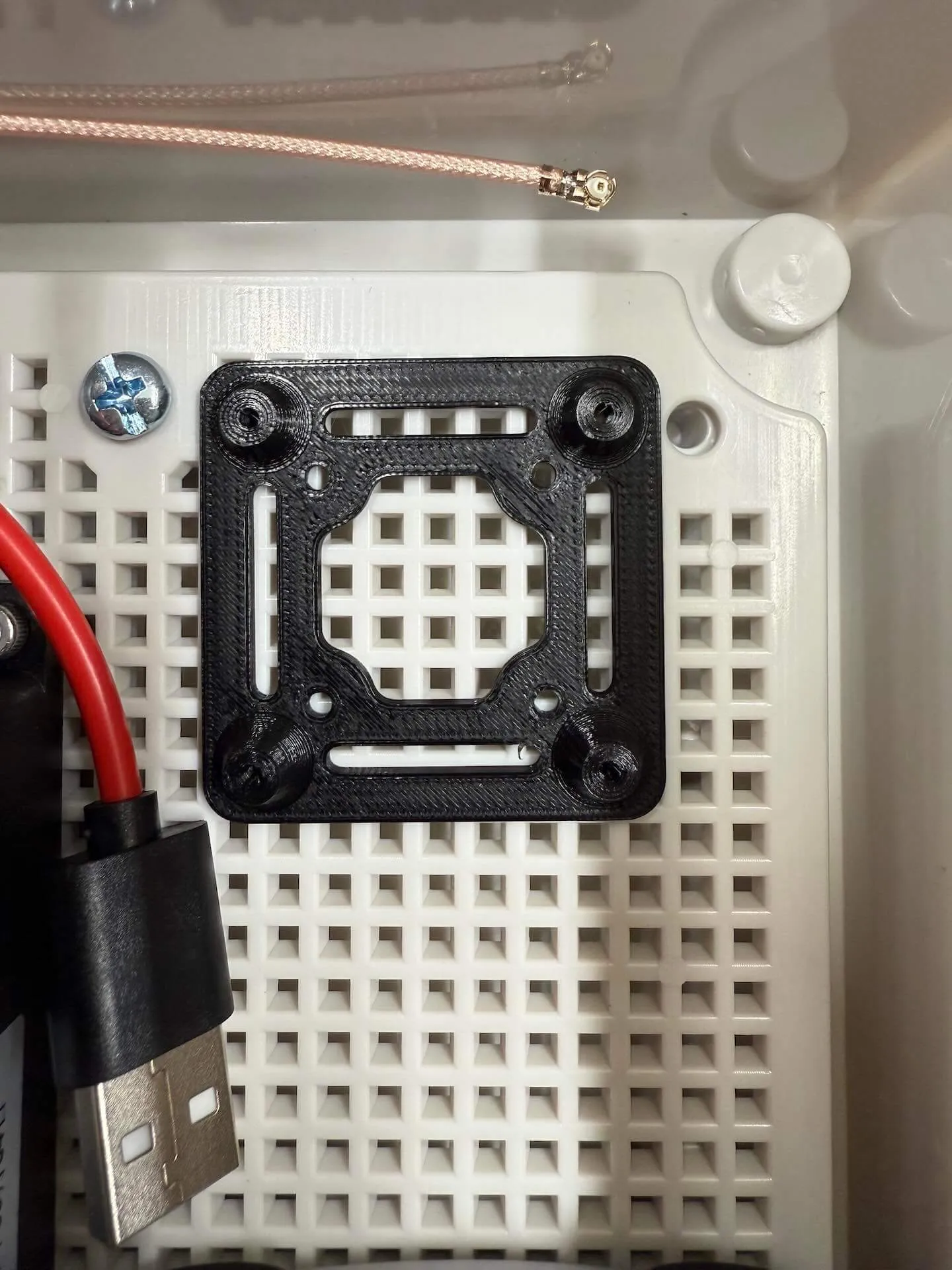 The custom 3D-printed mount that holds the Ikoka Nano inside the enclosure