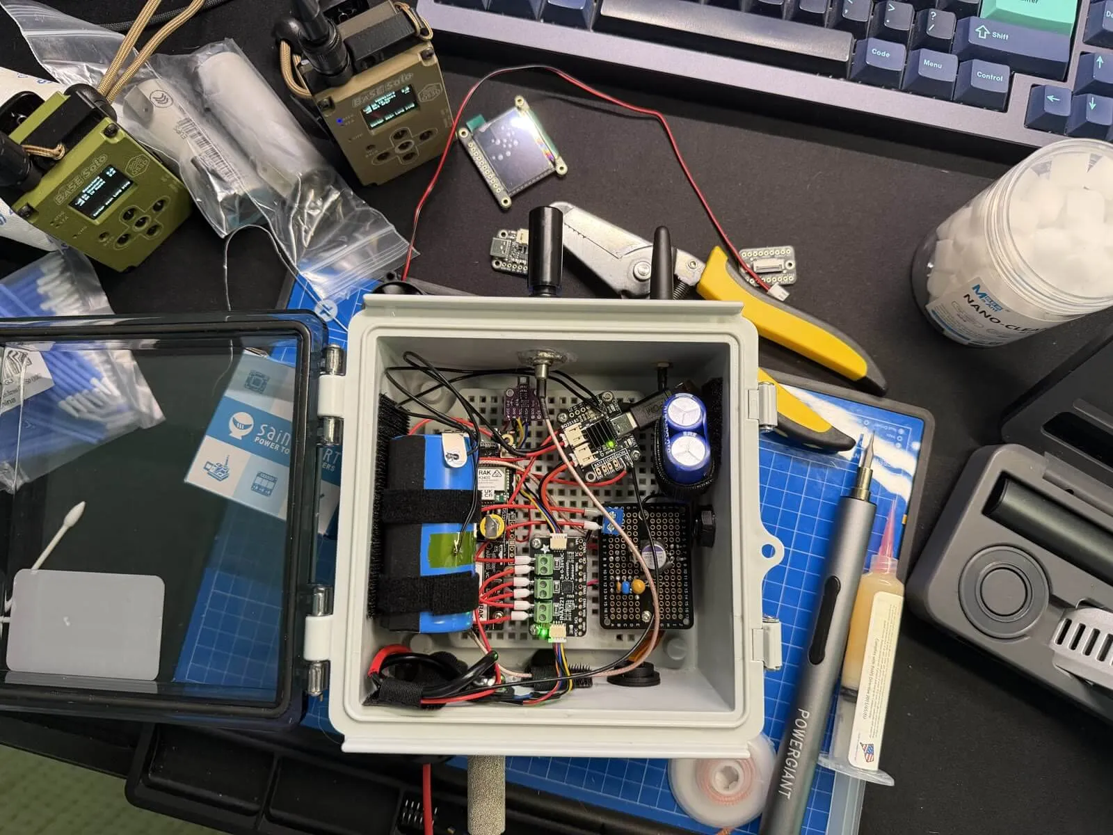 Inside view of the outdoor LiFePO4 solar 1W MeshCore repeater enclosure with radio, charger, sensors, regulator, and supercapacitor rail