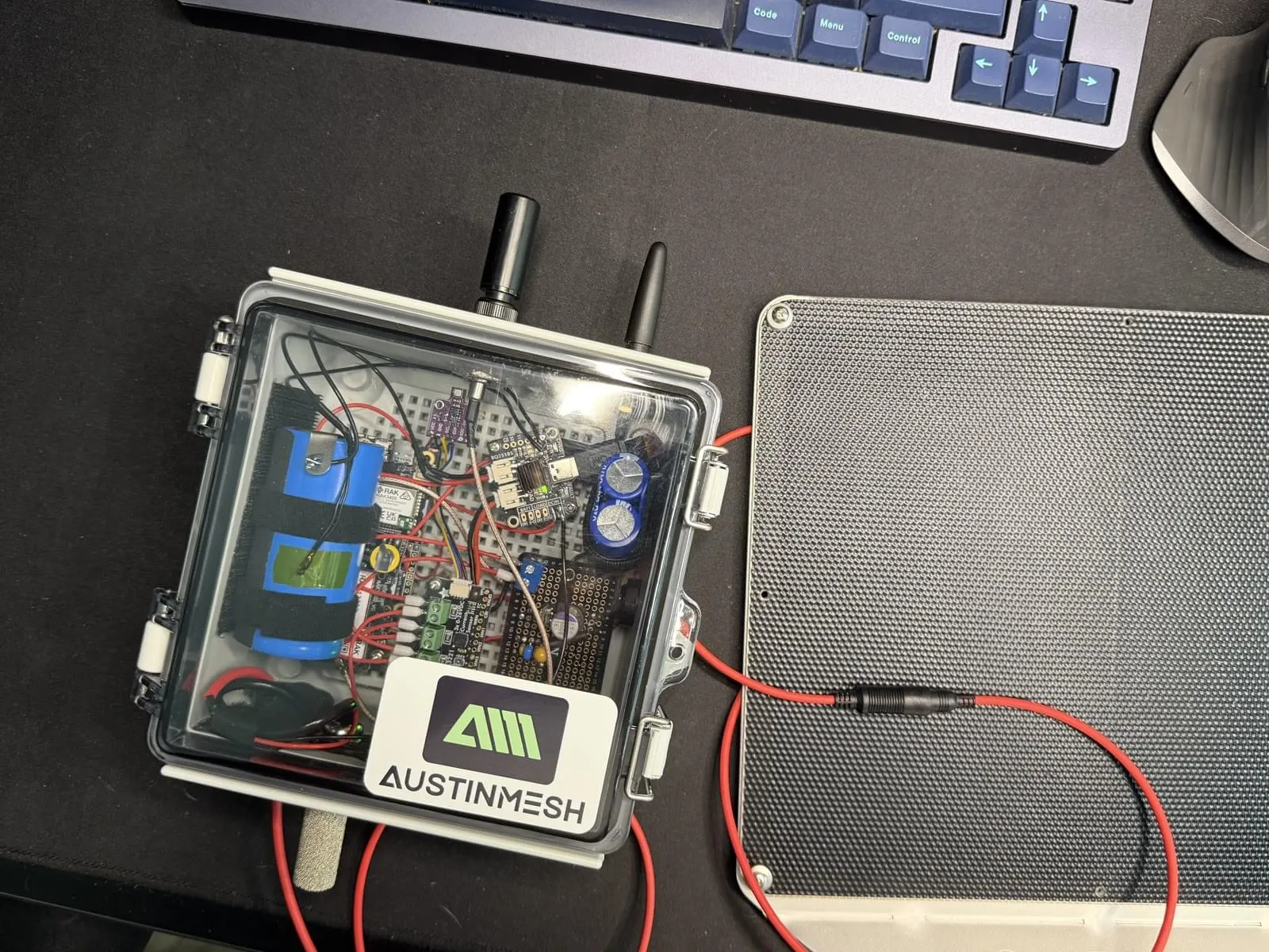 Outdoor 1W MeshCore repeater enclosure with Austin Mesh logo sticker