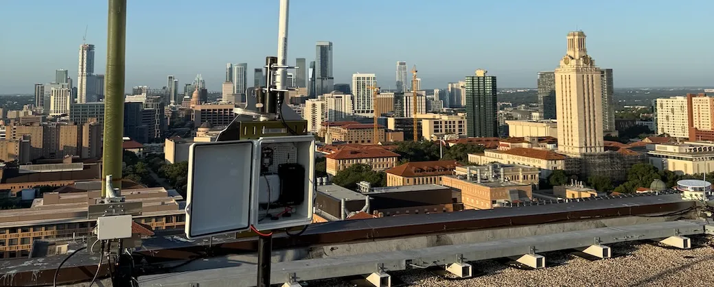 View looking out from the UT PMA building showing the Austin skyline with a Meshtastic node in the foreground